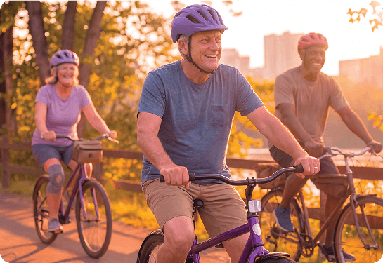 Three individuals riding their bikes.
