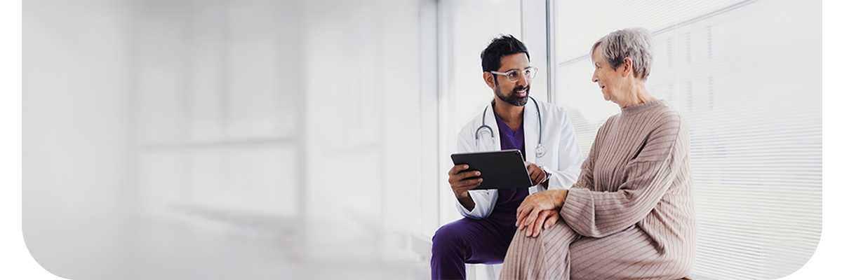 A physician and individual talking.