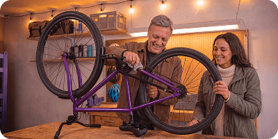 Man and woman fixing a bike.